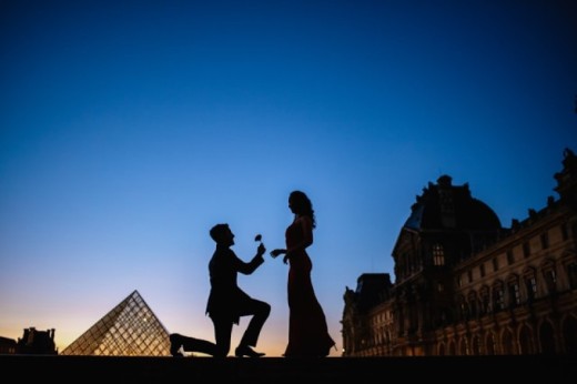 A silhouette of a couple proposing