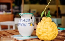 Ceramic jug and fresh large lemon displayed during an Amalfi Coast lemon tour.
