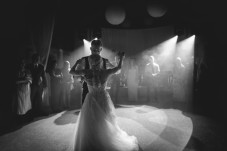 A black and white image of a bride and groom dancing on their wedding day. 